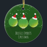 Ornamento De Cerâmica Bruxelas rebenta Natal de Santa Hat Comida Verde<br><div class="desc">Um Enfeites de natal comida divertido que apresenta um sorriso de couve-de-bruxelas em Papai Noel em um fundo verde com neve decorativa e estrelas. As palavras dizem "Bruxelas brota o Natal" e podem ser personalizadas. O esquema de cores está em tons de verde vegetal, branco e vermelho. Este alimento, novidade,...</div>