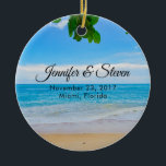 Ornamento De Cerâmica Casamento na Ilha Tropical Beach Vacing Island<br><div class="desc">Ornamento de lembrança de casamento com fotografia de paisagem de uma praia tropical. Areia quente,  água azul e azul com folhas tropicais ao longo do topo.</div>