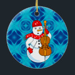 Ornamento De Cerâmica Cello Snowman<br><div class="desc">Um boneco de neve vestindo um cachecol de anotações musicais e segurando um violoncelo é um design musical engraçado para músicos de cordas em orquestra e quartetos de cordas.</div>