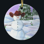 Ornamento De Cerâmica Cowboy Snowman<br><div class="desc">Cowboy Snowman ilustrou a fotografia. Ele veste um chapéu de cowboy marrom,  sentado em rolos de neve com pinheiros e pôr do sol roxo ao fundo.</div>