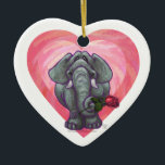 Ornamento De Cerâmica Dia de os namorados de elefante<br><div class="desc">Parada Animal Elephant Love and Hearts Day Gifts and Accessories (Presentes e Acessórios do Dia do Namorados Romântico de Elefante Romântico e Corações) apresenta nossa divertida trabalho de arte de um elefante bonito segurando um rosa bonito na boca com corações roxos, vermelhos e cor-de-rosa atrás dela criados pelo nosso talentoso...</div>