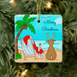 Ornamento De Cerâmica Feliz Papai noel de Natal em Beach com Reindeer<br><div class="desc">A mão desenhou o humor do pássaro de neve. Papai Noel sentado em uma praia em uma cadeira de grama com uma rena olhando pelo oceano.</div>