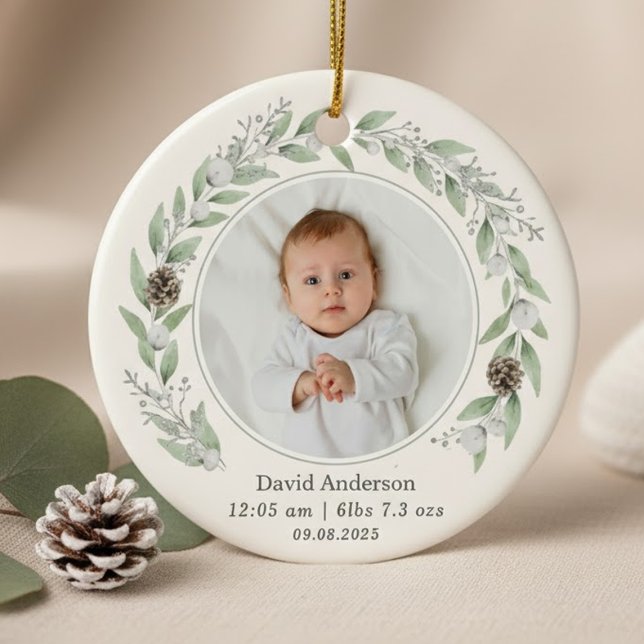 Ornamento De Cerâmica Foto da Criança Holly Wreath Natal 2025 (A round ornament featuring a central baby photo circled by a delicate watercolor greenery wreath.)