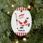 Ornamento De Cerâmica Guarda Personalizada de Hóquei em Campo<br><div class="desc">Design de hóquei em campo criativo com Papais noeis com um bastão de hóquei candi. Editar texto para adicionar nome e ano.</div>