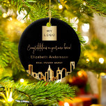 Ornamento De Cerâmica Logotipo do agente imobiliário da Skyline City em<br><div class="desc">Um fundo negro,  com uma falsa linha do horizonte de ouro como decoração. Personalize e adicione o logotipo da sua empresa e um texto à frente. Cartas de ouro Um presente para seus clientes - parabéns em uma nova casa.</div>