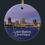 Ornamento De Cerâmica Long Beach California, Skyline em Dusk,<br><div class="desc">Skyline de Long Beach,  Califórnia ao anoitecer no lado frontal deste ornamento lateral. Uma imagem detalhada do volante no navio Rainha Mary no verso. Altere a data do ano para o ano de sua escolha.</div>