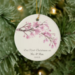 Ornamento De Cerâmica Nosso Primeiro Natal como Sr. e Sra. Cherry Blosso<br><div class="desc">Você se casou este ano? Adicione uma memória à sua árvore com este elegante ornamento cerâmico de manutenção floral com um galho constituído por flores cor-de-água pintadas de cereja cor-de-rosa floridas no topo sobre um fundo de marfim. Abaixo está a mensagem "Nosso Primeiro Natal como Sr. e Sra." e o...</div>