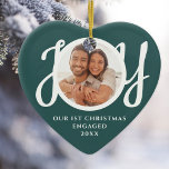 Ornamento De Cerâmica Our First Christmas Engaged Photo Heart-Shaped<br><div class="desc">This keepsake festive green heart-shaped First Christmas Engaged photo ceramic ornament is decorated with the word JOY in stylish white script typography. Easily customizable.</div>