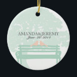 Ornamento De Cerâmica Pássaros em um aniversário de casamento em Park Be<br><div class="desc">Este casamento da cidade elegante e elegante, primeiro Natal junto com o ornamento, mostra aves de pomba na moda sentadas num banco de campo sob um gigante avô, carvalho, em verde-menta, pêssego e cores brancas! Um design bonito e chique para qualquer casamento ao ar livre em um jardim também. Procure...</div>