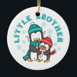 Ornamento De Cerâmica Pinguim Winter Little Brother<br><div class="desc">Dois pinguins bonitos em cachecóis e chapéus de inverno,  o pequeno comendo um cone de sorvete,  flocos de neve por toda parte,  com neve derramada de texto 'Little Brother'. Tem design de irmão mais velho e designs irmãs.</div>