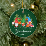 Ornamento De Cerâmica Primeiro Natal Avós Gnomos Luzes Verdes<br><div class="desc">Nosso Primeiro Natal como Avós Coloridos Gnomos de Cores-d'água Difundidos com Ornamento de Pinheiros - Fundo Verde Florestal e Luzes de Cordas</div>