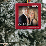 Ornamento De Cerâmica Primeiro Natal Envolvido | Árvore de Natal de Foto<br><div class="desc">Na moda foto do ornamento da árvore de natal, para todos aqueles casais amados que recentemente se engajaram ou se casaram. Esta decoração de árvore tem uma borda vermelha de morango, com texto que lê o ano, engajado em letra de script, e os nomes dos casais, adicione sua foto favorita...</div>