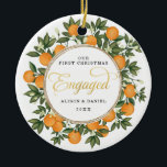 Ornamento De Cerâmica Primeiro Natal Envolvido Citrus Greenery<br><div class="desc">Este Enfeites de natal inspirado pelos citros apresenta laranjas pintadas à mão lindas e um verde-azul exuberante. Excelente para um casamento de verão! Os campos de texto são totalmente editáveis, exceto a palavra "Engaged". Basta remover esta palavra clicando no botão excluir e adicionar seu próprio texto se você precisar de...</div>