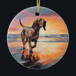 Ornamento De Cerâmica Sandy Paws Bloodhound Dog em Beach Sunset<br><div class="desc">Mergulhe na beleza tranquila do nosso cão "Sandy Paws and Sunset Hues" na design do pôr do sol da praia. Esta cena cativante captura a essência de uma noite perfeita na costa, com um companheiro leal canino desfrutando das areias ouros e das lutas respiratórias do sol. Quer você seja um...</div>