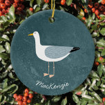 Ornamento De Cerâmica Seagull Personalizado<br><div class="desc">Uma gaivota divertida ao lado do oceano verde profundo. Perfeito para aqueles que amam pássaros sassos e a costa. Arte original de Nic Squirrell. Altere o nome para personalizar.</div>