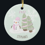 Ornamento De Cerâmica Snowman Christmas<br><div class="desc">O Natal de Snowman Comemora o aniversário de inverno do seu filho com este bonitinho e bonitão a vestir um chapéu e lenço cor-de-rosa pastel. Este tema é ideal para o seu pequeno aniversário de inverno ou para a festa de Natal da criança. O design é completamente personalizável. Veja o...</div>