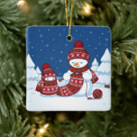 Ornamento De Cerâmica Snowman Knitting Christmas Scarf<br><div class="desc">Cartoon illustration of two adorable snowmen dressed in knitted hats and scarves. The big snowman is knitting an oversized scarf for the little one. The scarf is already wrapped several times around the cute little snowman.</div>
