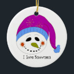 Ornamento De Cerâmica Snowman Sorridente<br><div class="desc">Um bonitinho bonitinho vestindo um chapéu roxo e azul,  um grande sorriso e um ditado fofo acentua esse design.</div>