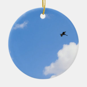 Ornamento De Cerâmica Solitary Bird Soaring Through Bright Blue Sky with