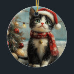 Ornamento De Cerâmica Tuxedo Cat Christmas Vintage Beach<br><div class="desc">Traga o calor dos feriados para a costa com esta charmosa design inspirada na vintagem, apresentando um Gato festivo sentado numa praia de sereno. Com um clássico toque de feriado de tons nostálgicos e vibrações costeiras, esta trabalho de arte captura a magia do Natal pelo mar. Perfeito para espalhar alegria...</div>