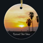 Ornamento De Cerâmica Venice Beach California Sunset Souvenir Cerâmica O<br><div class="desc">Esta imagem fotográfica mostra palmeiras altas na silhueta em pé contra um lindo amarelo vívido, ouro, laranja e pôr do sol vermelho sobre o Oceano Pacífico na praia de Veneza, Califórnia. Adicione texto opcional ou datas de férias para uma de uma lembrança exclusiva. Outro design exclusivo original do Código de...</div>