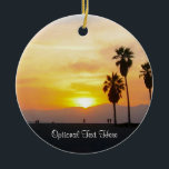 Ornamento De Cerâmica Venice Beach California Sunset Souvenir Cerâmica O<br><div class="desc">Esta imagem fotográfica mostra palmeiras altas na silhueta em pé contra um lindo amarelo vívido, ouro, laranja e pôr do sol vermelho sobre o Oceano Pacífico na praia de Veneza, Califórnia. Adicione texto opcional ou datas de férias para uma de uma lembrança exclusiva. Outro design exclusivo original do Código de...</div>
