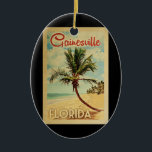 Ornamento De Cerâmica Viagens vintage de Árvore Gainesville Palm<br><div class="desc">Um impressão de arte moderno do século médio único,  Gainesville Flórida,  no estilo da poster viagens vintage. Ele apresenta uma palmeira curva na praia arenosa com oceano sob um céu azul nublado.</div>