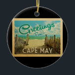 Ornamento De Cerâmica Viagens vintage de praia de Cape May<br><div class="desc">Esta saudação do Cabo de maio vintage postcard design apresenta uma praia arenosa com uma bela água turquesa oceânica e acima do mar,  um céu azul com nuvens brancas e onduladas. No estilo viagens vintage.</div>