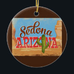 Ornamento De Cerâmica Viagens vintage do Deserto de Cartoons de Arizona<br><div class="desc">Design neo viagens vintage de Arizona de de de Sedona em engraçada desenho animado com estilo retrógrado do deserto,  cacto e rochas. Azul,  marrom e vermelho com cacto verde.</div>