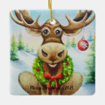 Ornamento De Cerâmica Whimical Winter Christmas Moose Watercolor Art<br><div class="desc">O ornamento cerâmico de "alça de Natal" da Aquarela Arte pelo artista Jean Weiner, "alce de Natal", apresenta uma alça de inverno caprichosa, pronta para comemorar o Natal. Este alce está vestindo uma nova coroa de verduras sagradas ao redor do pescoço. A coroa tem bagas vermelhas e um arco vermelho...</div>