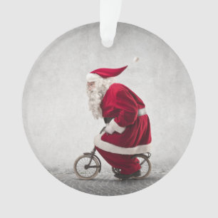 Ornamento Papai Noel monta uma bicicleta