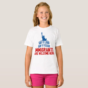 Os imigrantes dão boas-vindas ao t-shirt da menin
