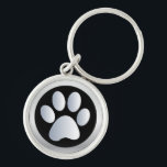 Pata de cão prateada, chaveiro preto, ideia de pre<br><div class="desc">Belo chaveiro de impressão de um cão de estimação preto e prateado ou de uma pata de gato,  com teclado.  ideia de presente de excelente para amantes de cães</div>