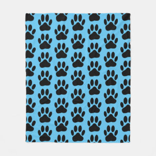 Pawprint do cão no cobertor azul de velo