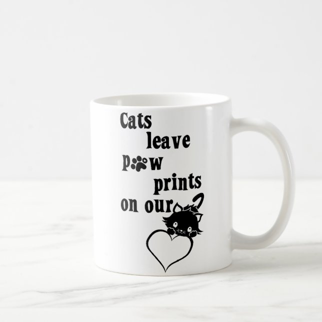 Pawprints da licença dos gatos em nossa caneca dos (Direita)