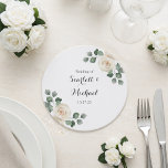 Porta-copo De Papel Redondo White roses Spring Floral Romantic Wedding<br><div class="desc">Add a thoughtful decorative touch to your reception tables with this beautifully designed wedding coaster inspired by a watercolor white roses garden wedding theme. The design features soft white rose florals paired with delicate greenery placed around the edges, creating a balanced botanical composition that feels romantic and refined. This gentle...</div>