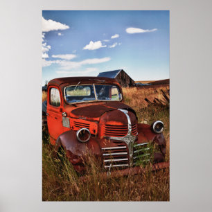 Póster Rusting orange Dodge truck with abandoned farm