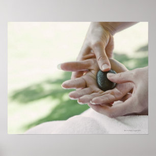 Póster Woman getting hand massage with hot stone