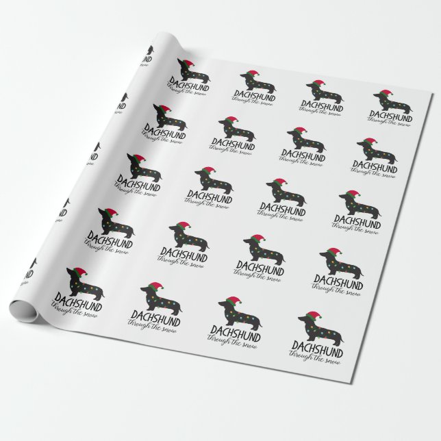 Presente Dachshund através do papel de envolvimento da neve (Desenrolado)