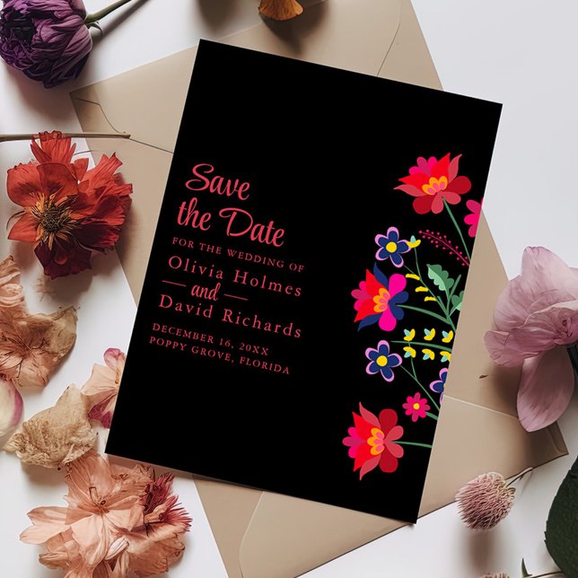 Preto Mexicano Floral Fiesta Salve o Cartão de Dat (Black Mexican Floral Fiesta Save the Date Card on a table with colorful flowers.)