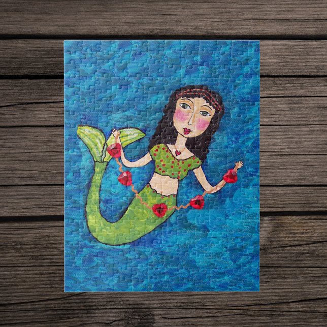 Quebra-cabeça Arte Popular Sereia Verde Corda de Corações Vermel (Mermaid with green tail holding gold string of red hearts on shades of blue jigsaw puzzle.)