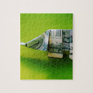 Quebra-cabeça Elefante do origami da nota de dólar no fundo
