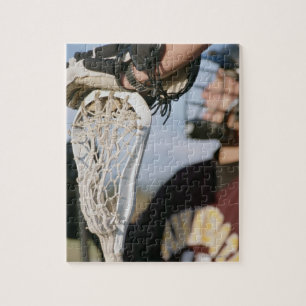 Quebra-cabeça Mão em uma vara do Lacrosse