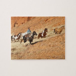 Quebra-cabeça Vaqueiro que reune cavalos