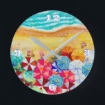 Relógio da Ronda de Guarda-chuvas da Praia de Verã<br><div class="desc">Ondas em uma praia arenosa,  banhistas sob guarda-chuvas coloridos,  este relógio é uma adição divertida à sua casa de praia ou decoração de verão ou dá como presente. CORRESPONDENDO a itens na nossa loja.</div>