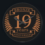 Relógio Grande Aniversário de casamento tradicional de Bronze, 19<br><div class="desc">Uma design para celebrar 19 anos de casamento. Este design tem um design de riso de bronze em fundo preto. Bronze é o presente tradicional para esta ocasião. O texto refere-se ao aniversário de 19 anos de bronze. Uma design romântica para celebrar o seu 19º ano de casamento. Se você...</div>