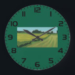 Relógio Grande Green Countryside Landscape<br><div class="desc">Keep time with a view of the peaceful outdoors using this minimalist green landscape wall clock. The flat art illustration of a quiet country meadow serves as a beautiful focal point for a kitchen, office, or living room. Its clean lines and soothing earth tones make it a functional piece of...</div>