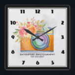 Relógio Quadrado Câmera Laranja Boho e Flores Aquarela<br><div class="desc">Relógio personalizado com seu nome comercial e número de telefone. Projetado com uma ilustração aquosa de uma câmera laranja e um buquê floral descansando no topo. As flores do buquê são rosas claro e laranja com folhas verdes,  um bonito arranjo floral.</div>