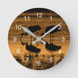 Relógio Redondo Gruas Silhuetadas pelo Sunset