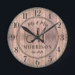 Relógio Redondo Newlyweds Rustic Personalizados<br><div class="desc">Um barninho moderno e rústico,  um escudo de madeira monograma com um relógio de casamento com data estabelecida e nome casado.</div>